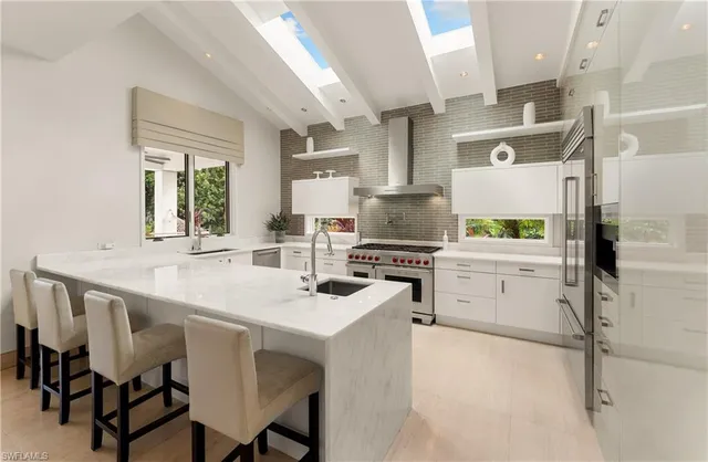 a kitchen with appliances cabinets and furniture