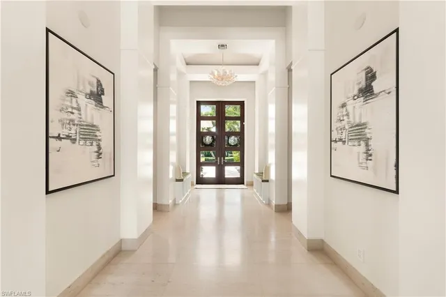 a view of a hallway with wooden floor and windows