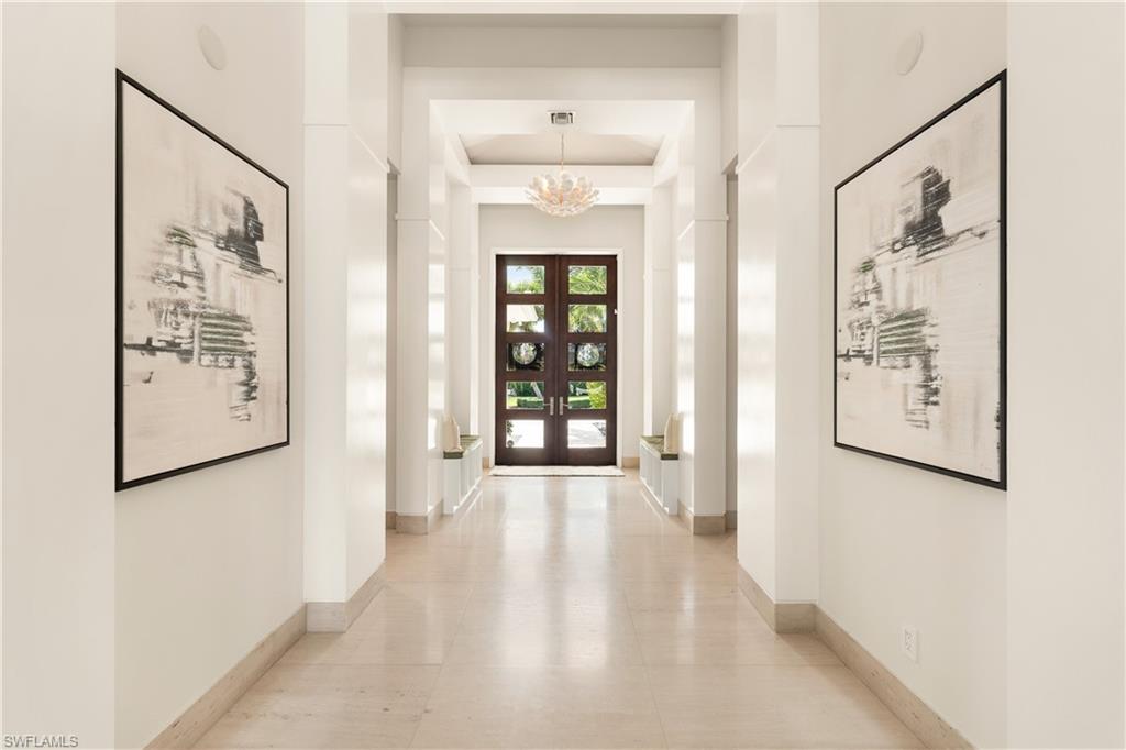 233 Ridge Drive Naples, FL 34108 - Photo 20 of 39 a view of a hallway with wooden floor and windows