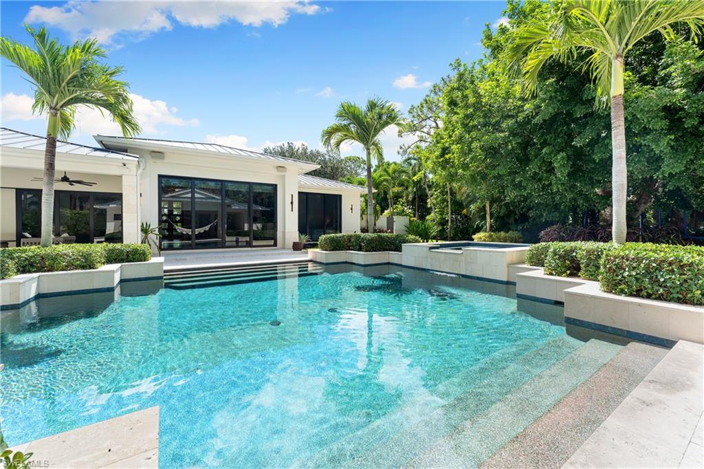 233 Ridge Drive Naples, FL 34108 - Photo 24 of 39 a swimming pool with outdoor seating and yard