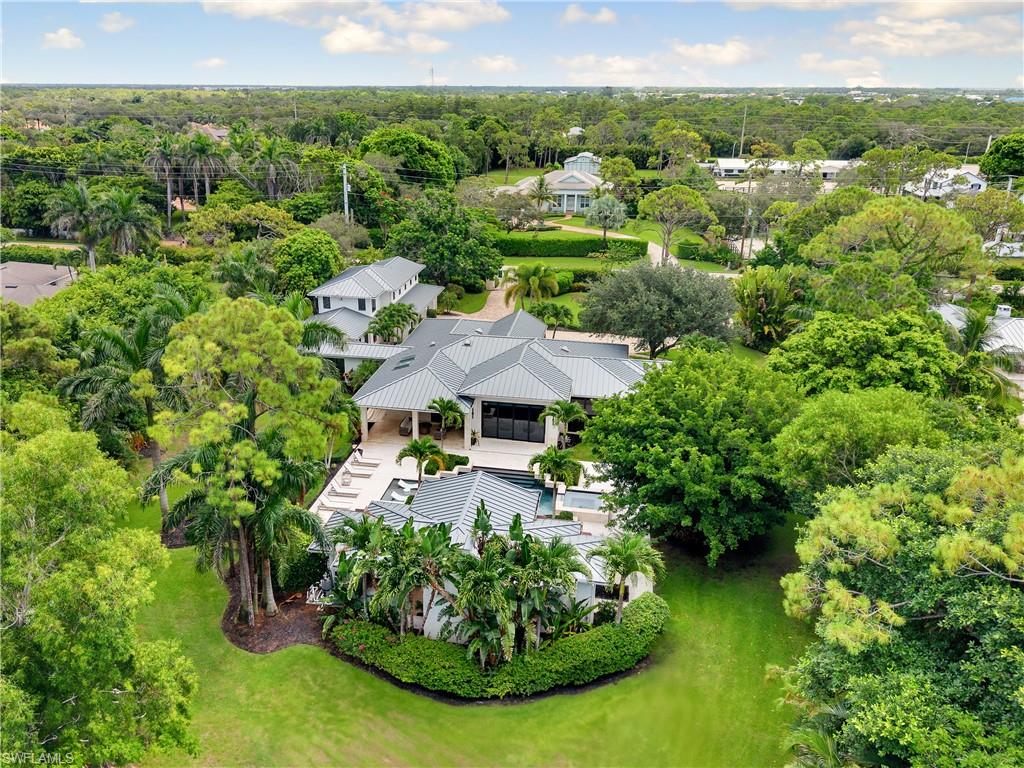 233 Ridge Drive Naples, FL 34108 - Photo 34 of 39 a view of a garden with a building in the background