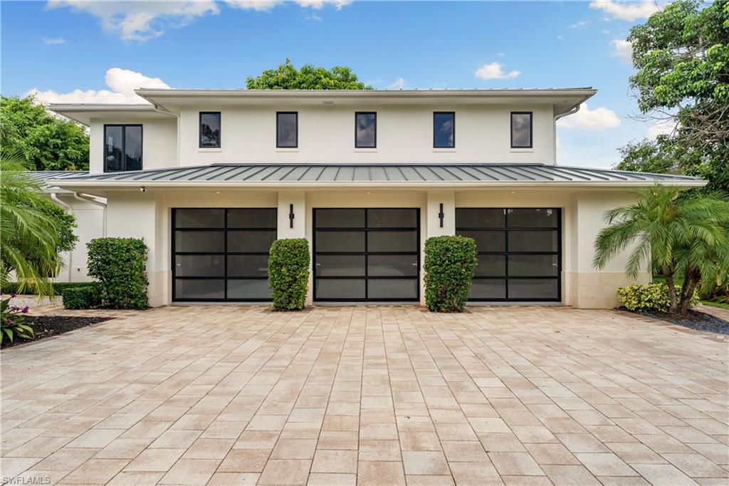 233 Ridge Drive Naples, FL 34108 - Photo 38 of 39 a front view of a house with a yard and garage