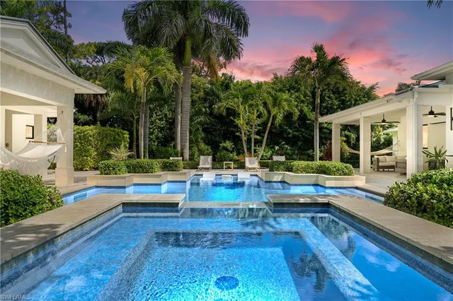 a view of house with swimming pool outdoor seating