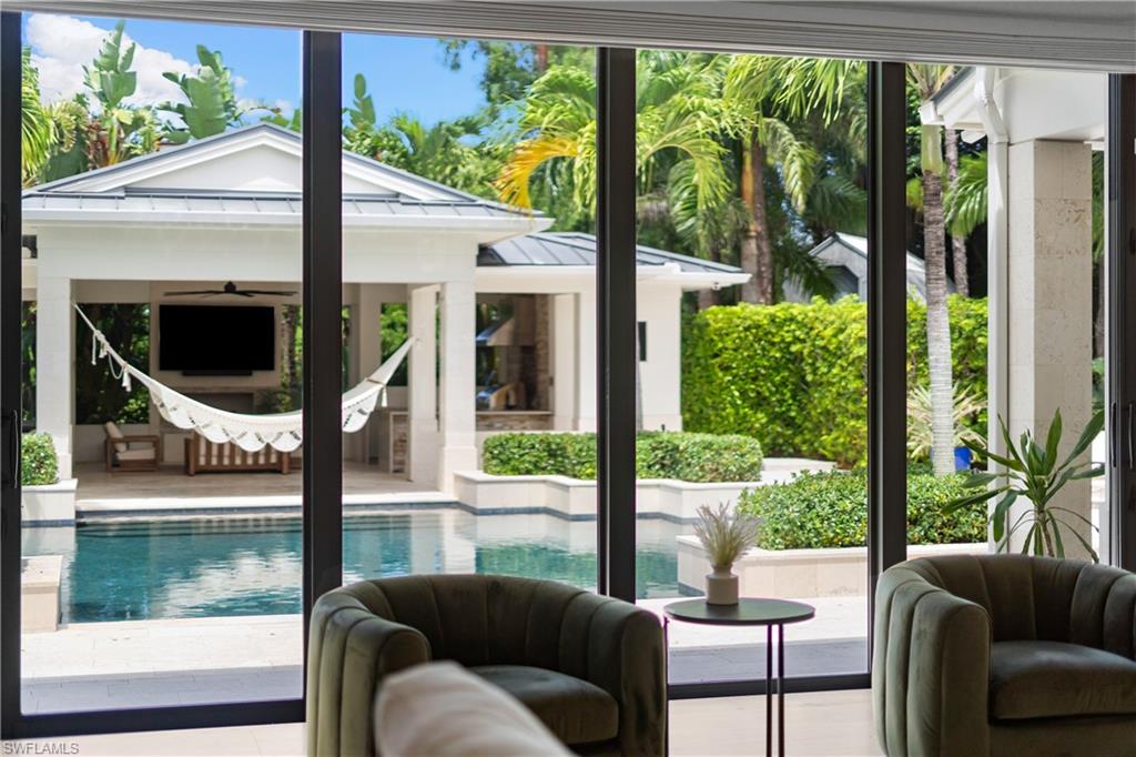 233 Ridge Drive Naples, FL 34108 - Photo 7 of 39 a balcony view with a large window and sitting area
