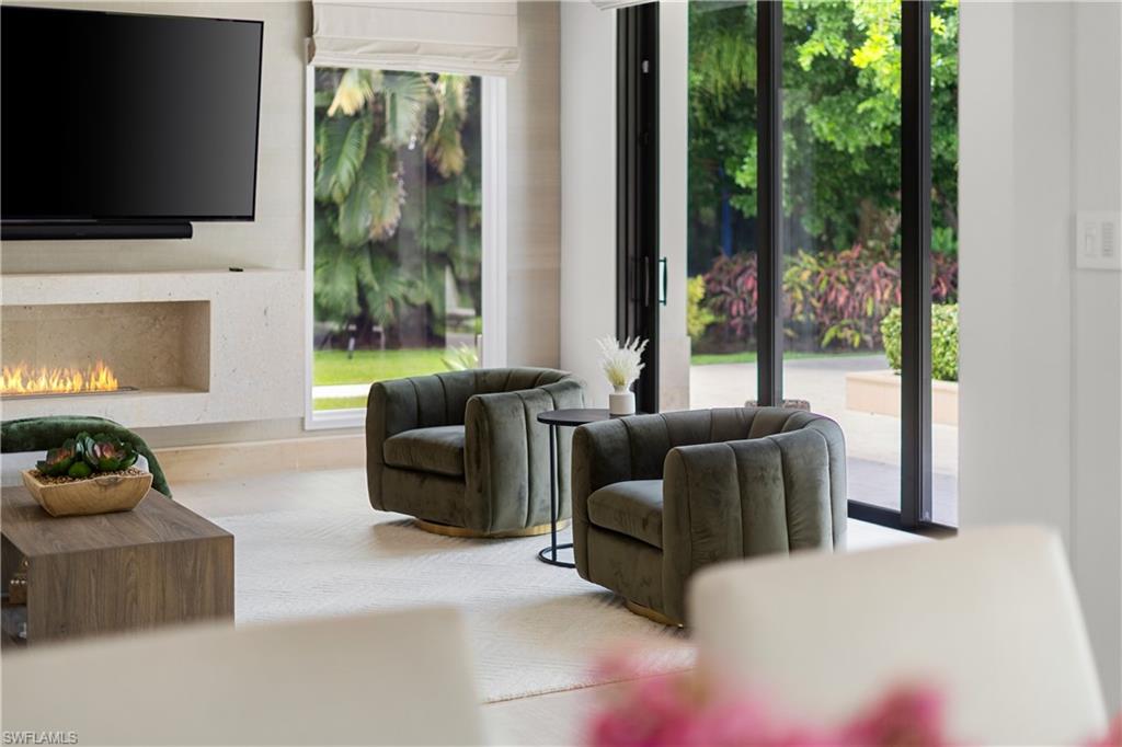 233 Ridge Drive Naples, FL 34108 - Photo 8 of 39 a living room with furniture fireplace and flat screen tv