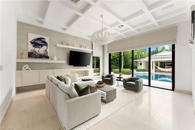 a living room with furniture tv and a large window