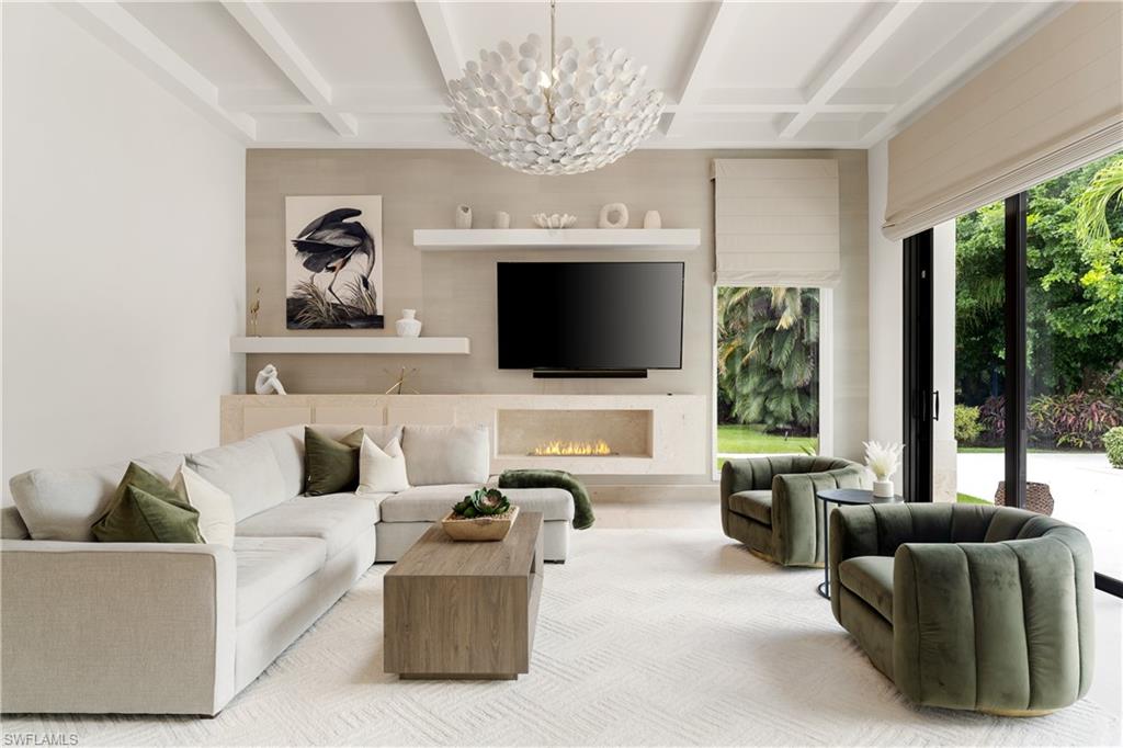 233 Ridge Drive Naples, FL 34108 - Photo 10 of 39 a living room with furniture a flat screen tv and a large window