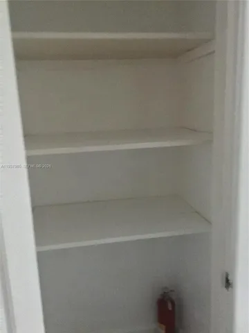 a kitchen with cabinets and window