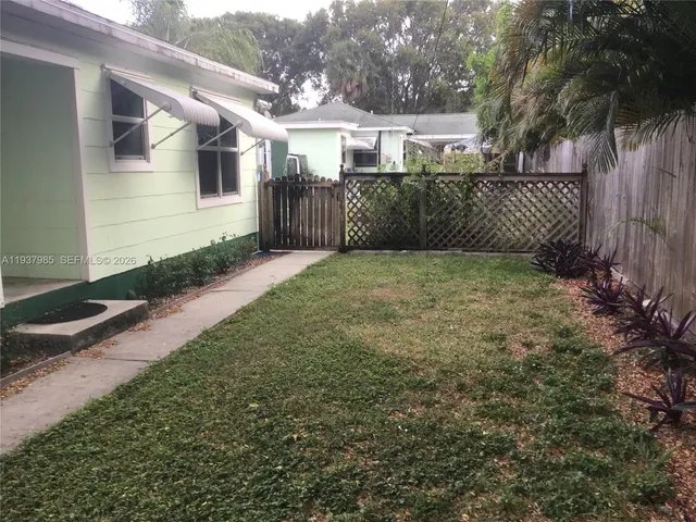 a view of a pathway of a building with wooden fence