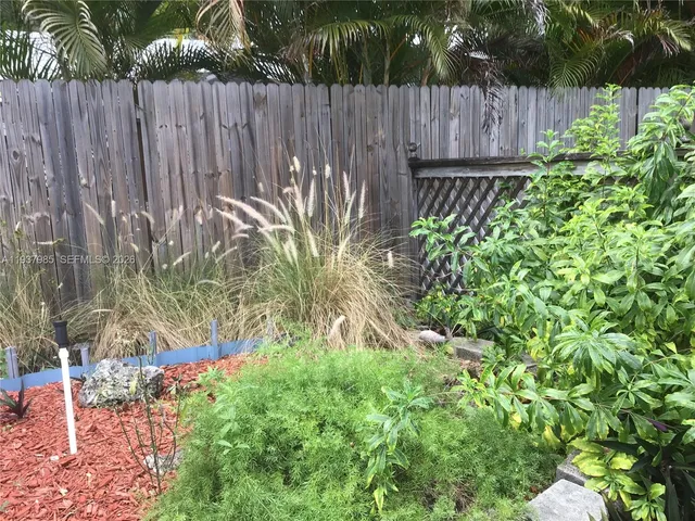 a garden with wooden fence