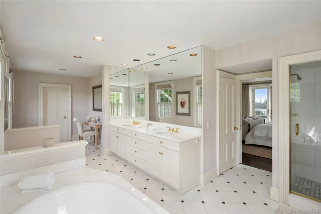 a bathroom with a bathtub sink and mirror