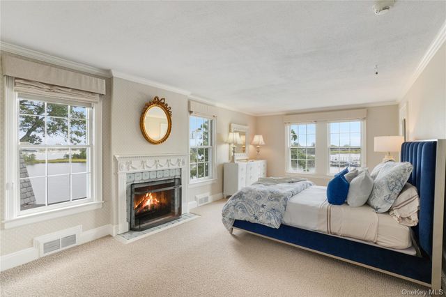 a bedroom with a bed and a fireplace