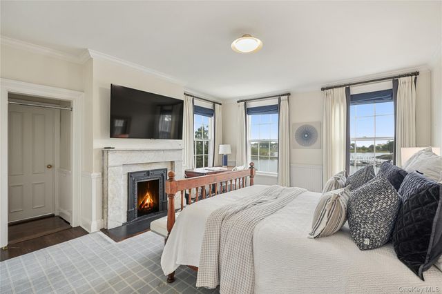 a bedroom with a bed and a fireplace