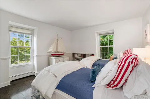 a bed sitting in a bedroom next to a window