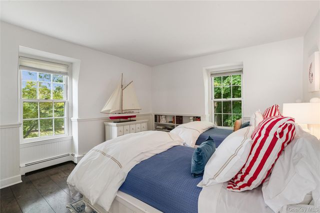 a bed sitting in a bedroom next to a window