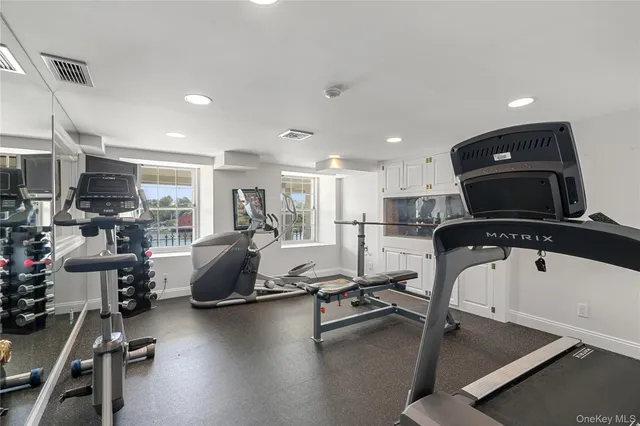 a room with gym equipment and a table