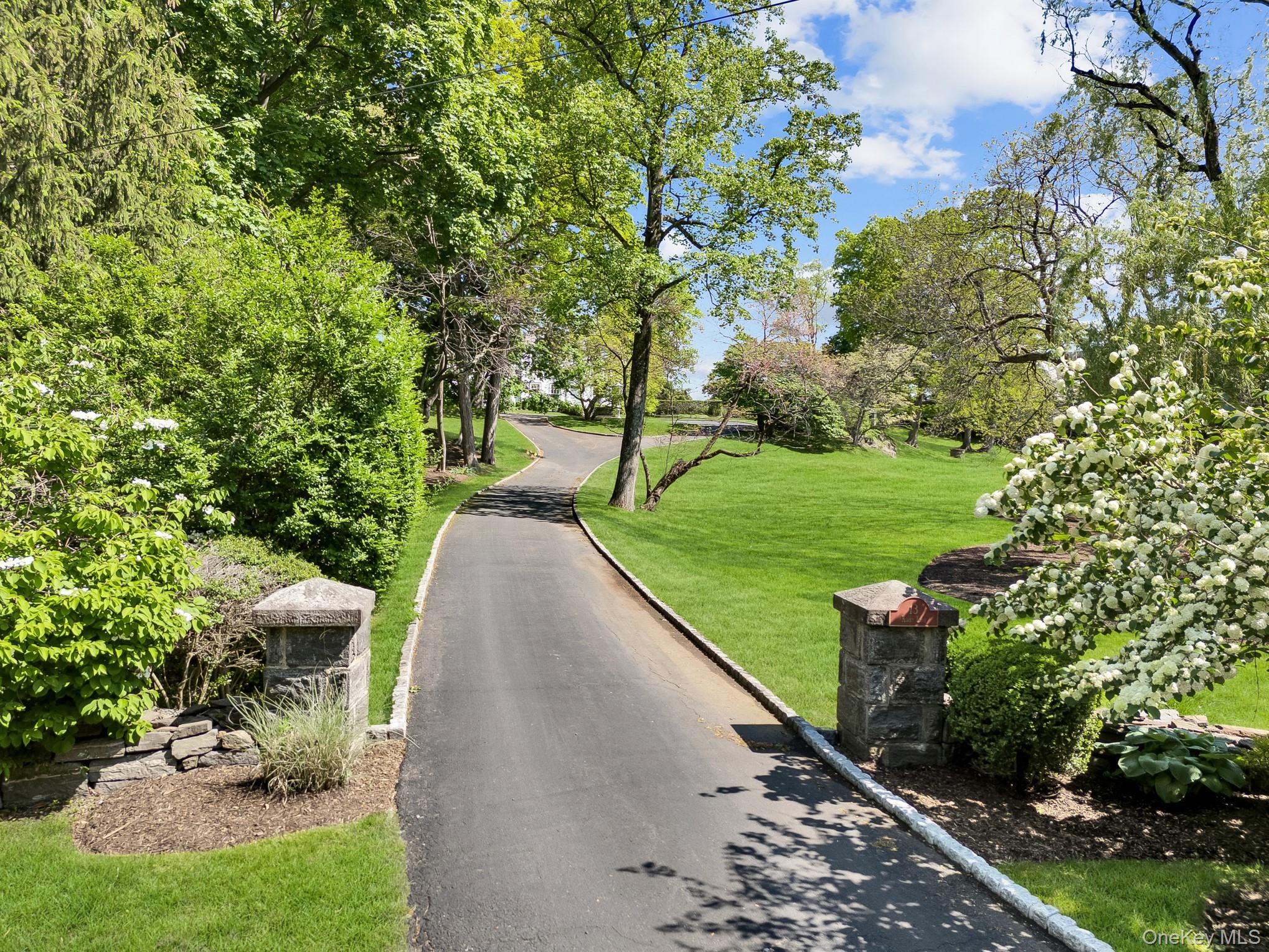 13 Kirby Lane Rye, NY 10580 - Photo 30 of 34 a view of a garden with plants and a bench
