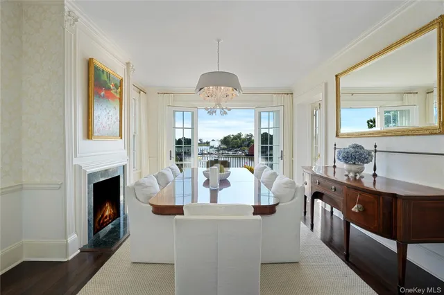 a living room with fireplace furniture and a chandelier