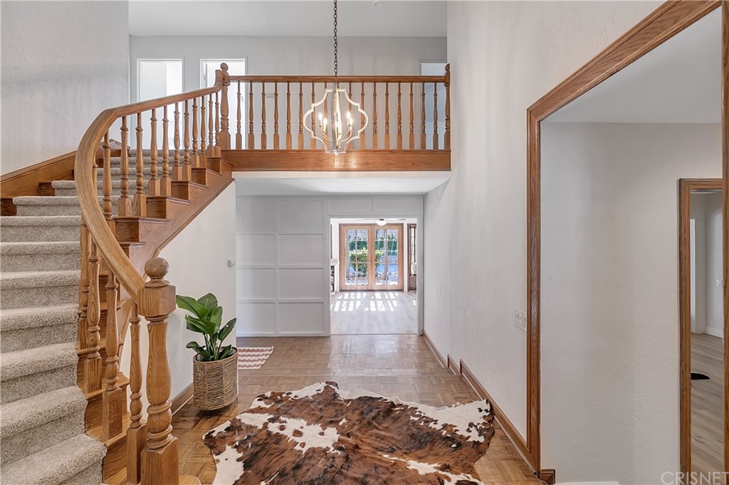 23646 Vía Corsa Valencia, CA 91355 - Photo 2 of 55 a view of staircase with wooden floor and a potted plant