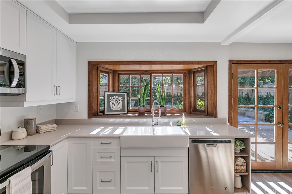 23646 Vía Corsa Valencia, CA 91355 - Photo 12 of 55 a kitchen with a sink stove and cabinets