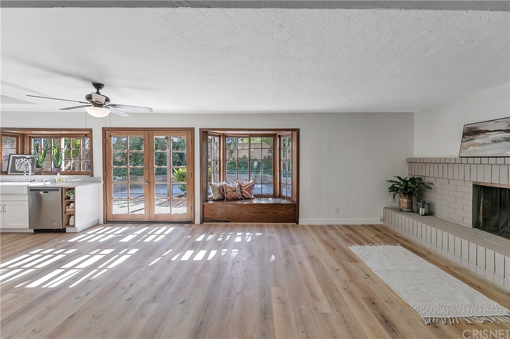23646 Vía Corsa Valencia, CA 91355 - Photo 17 of 55 a view of an empty room with a window and wooden floor