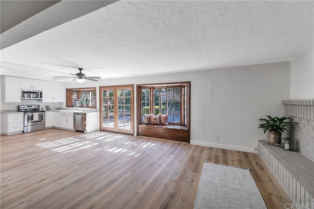 23646 Vía Corsa Valencia, CA 91355 - Photo 18 of 55 a view of an empty room with wooden floor and a window
