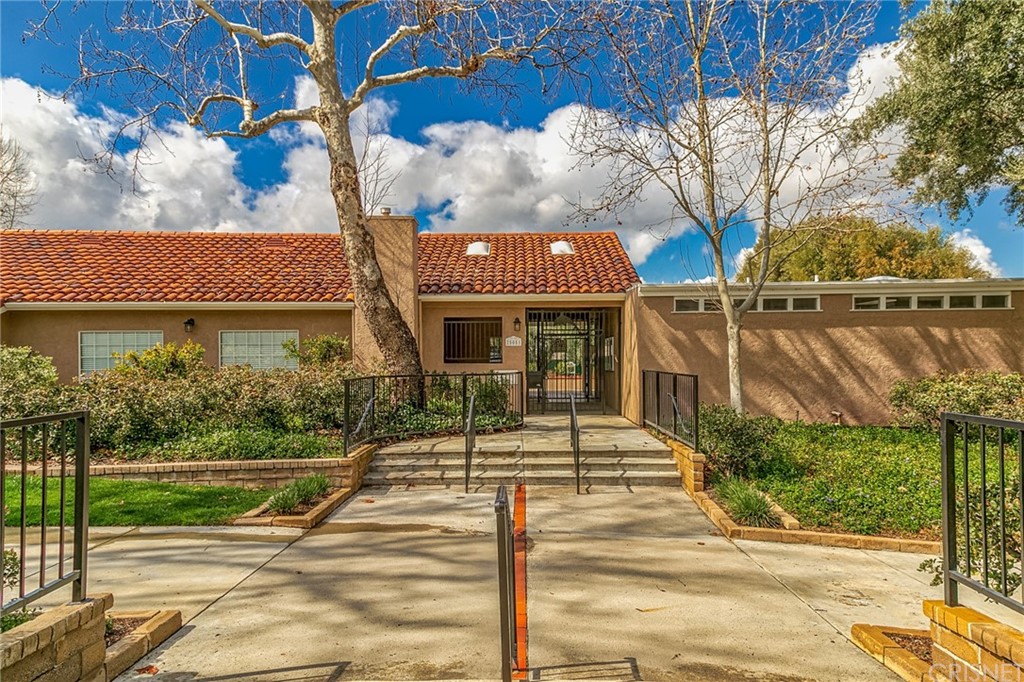 23646 Vía Corsa Valencia, CA 91355 - Photo 44 of 55 a front view of a house with a yard and potted plants