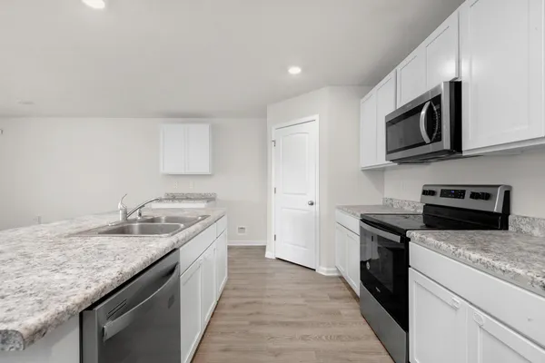 a kitchen with granite countertop stainless steel appliances and wooden cabinets