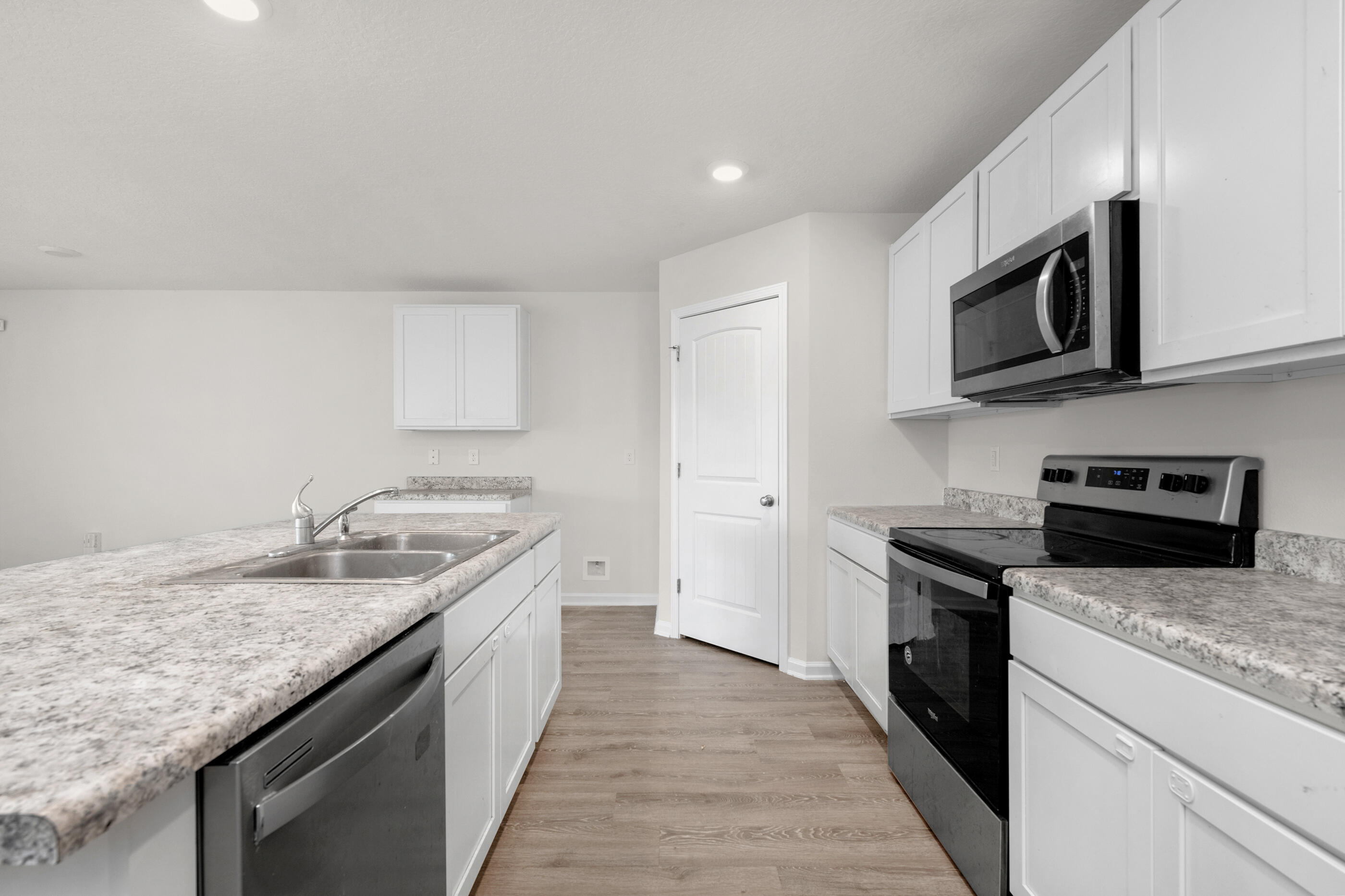 3524 Sugar Maple Lane Crestview, FL 32539 - Photo 12 of 24 a kitchen with granite countertop stainless steel appliances and wooden cabinets