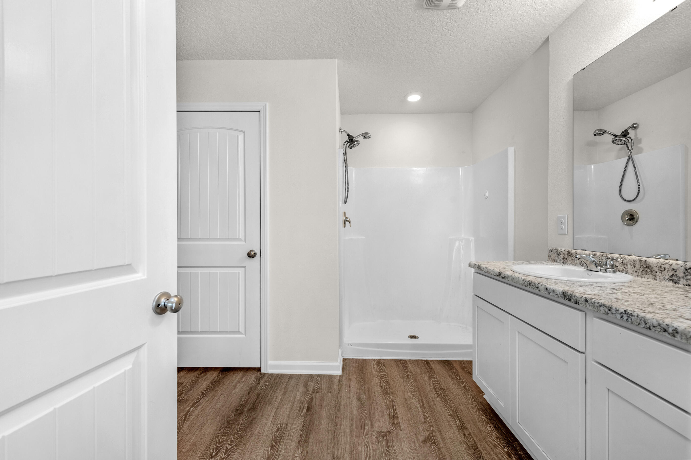 3524 Sugar Maple Lane Crestview, FL 32539 - Photo 13 of 24 a bathroom with a granite countertop sink a mirror and shower