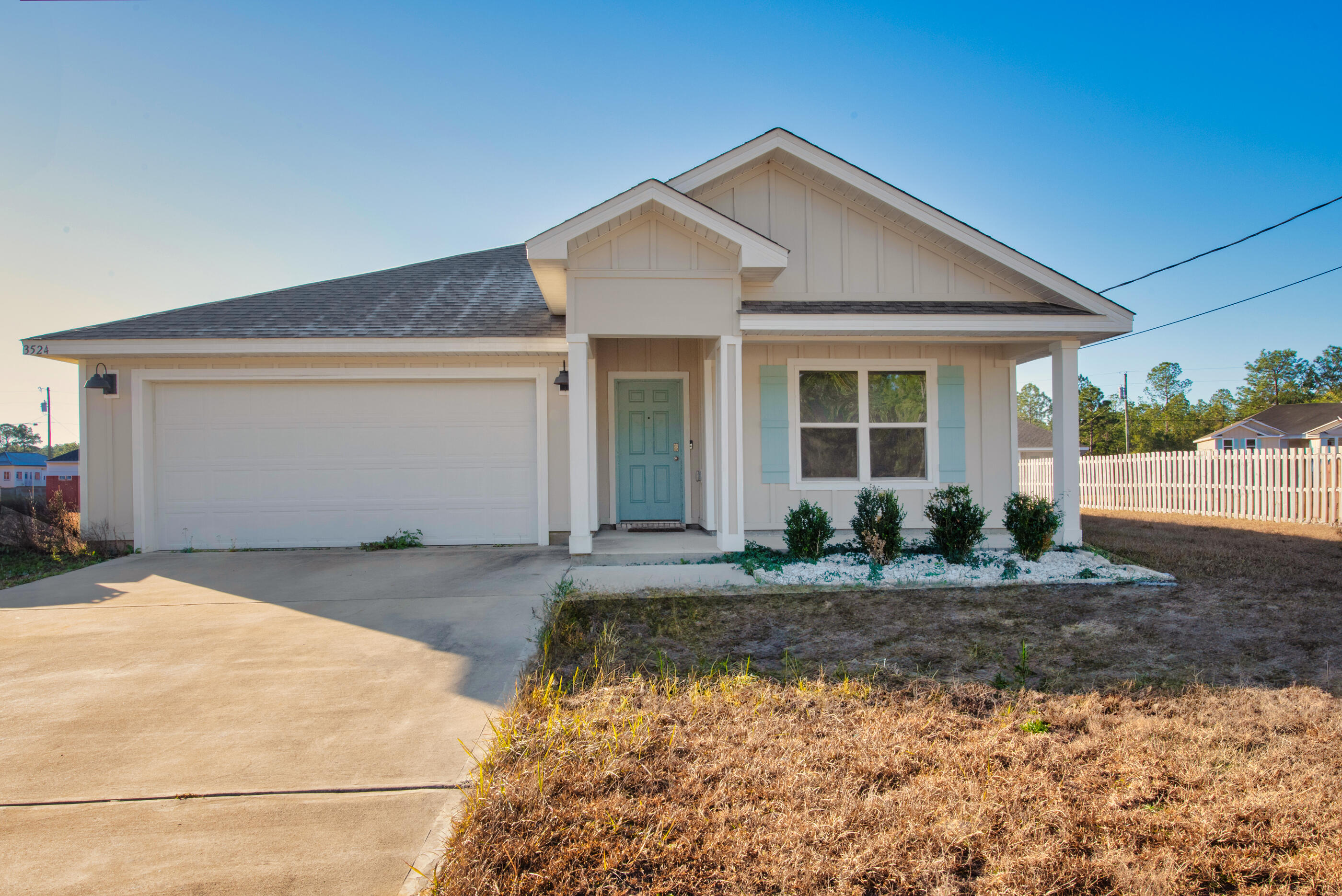 3524 Sugar Maple Lane Crestview, FL 32539 - Photo 2 of 24 a front view of a house with a yard and garage