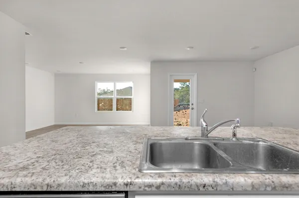 a kitchen with sink and window