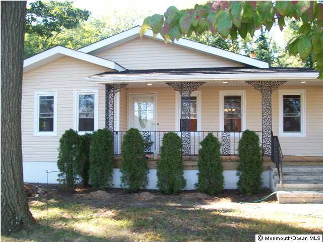 436 Middle Road Hazlet, NJ 07730 - Photo 3 of 3 a view of a white house with large windows and a small yard