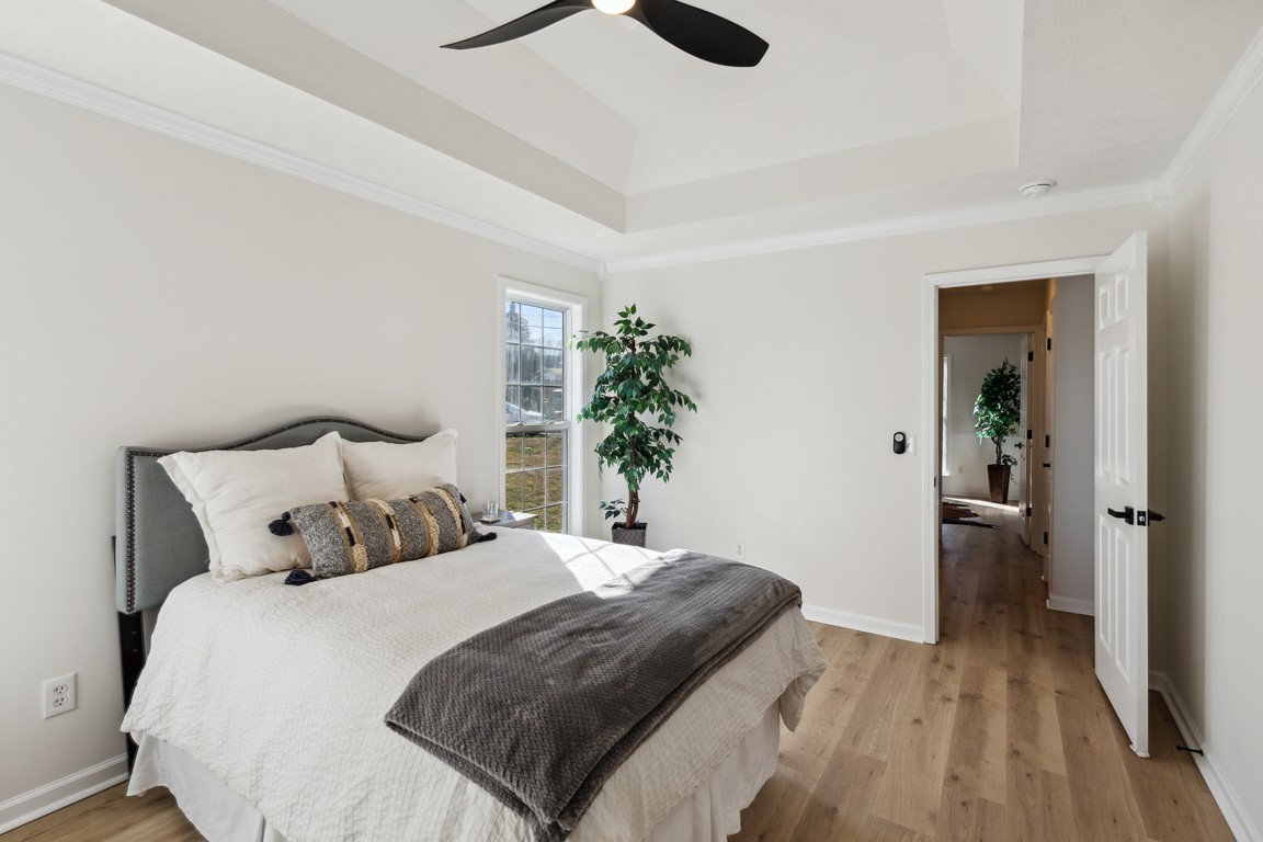 486 Berry Circle Springfield, TN 37172 - Photo 14 of 27 a bedroom with a bed and a potted plant