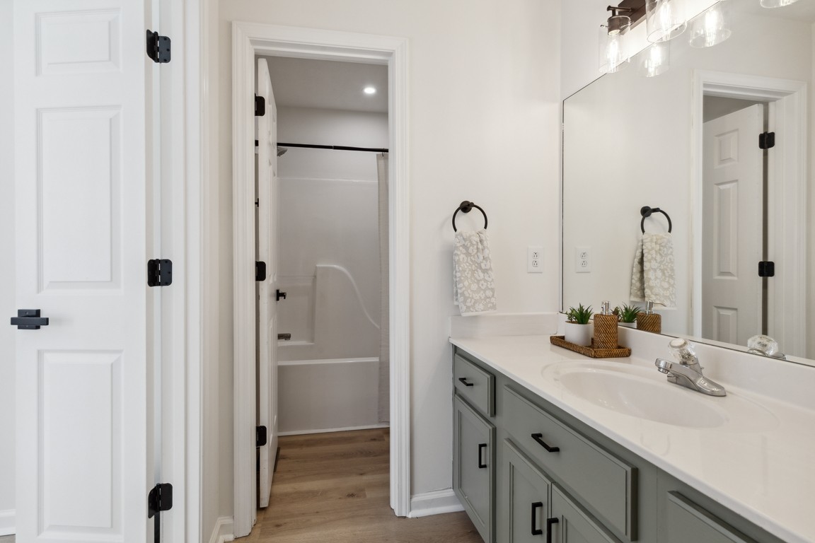 486 Berry Circle Springfield, TN 37172 - Photo 16 of 27 a bathroom with a double vanity sink shower and a mirror