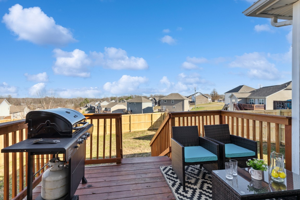 486 Berry Circle Springfield, TN 37172 - Photo 26 of 27 a view of a balcony with chairs and wooden floor