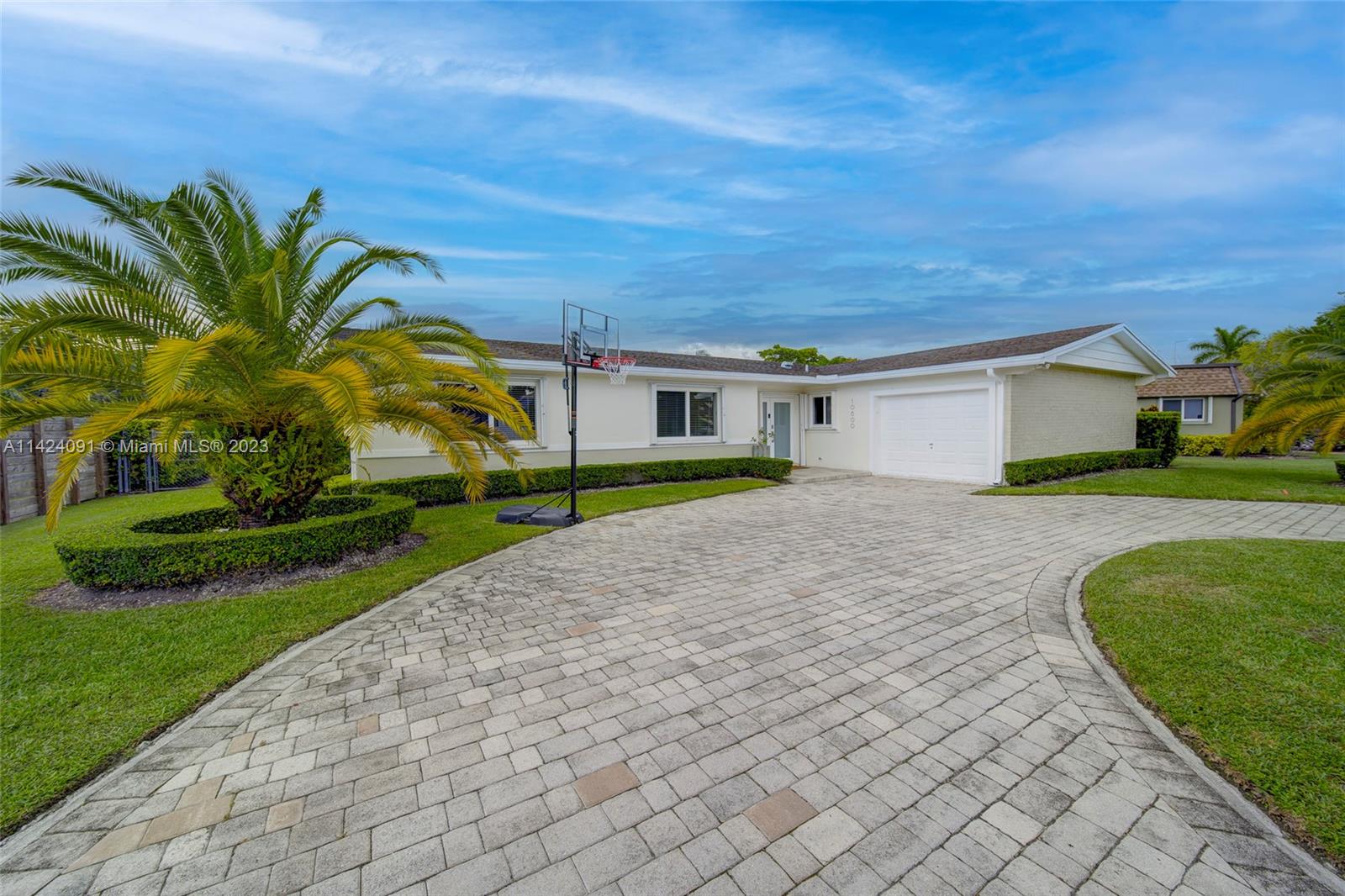 10600 Southwest 108th Terrace Miami, FL 33176 - Photo 1 of 43 a front view of a house with a yard and potted plants