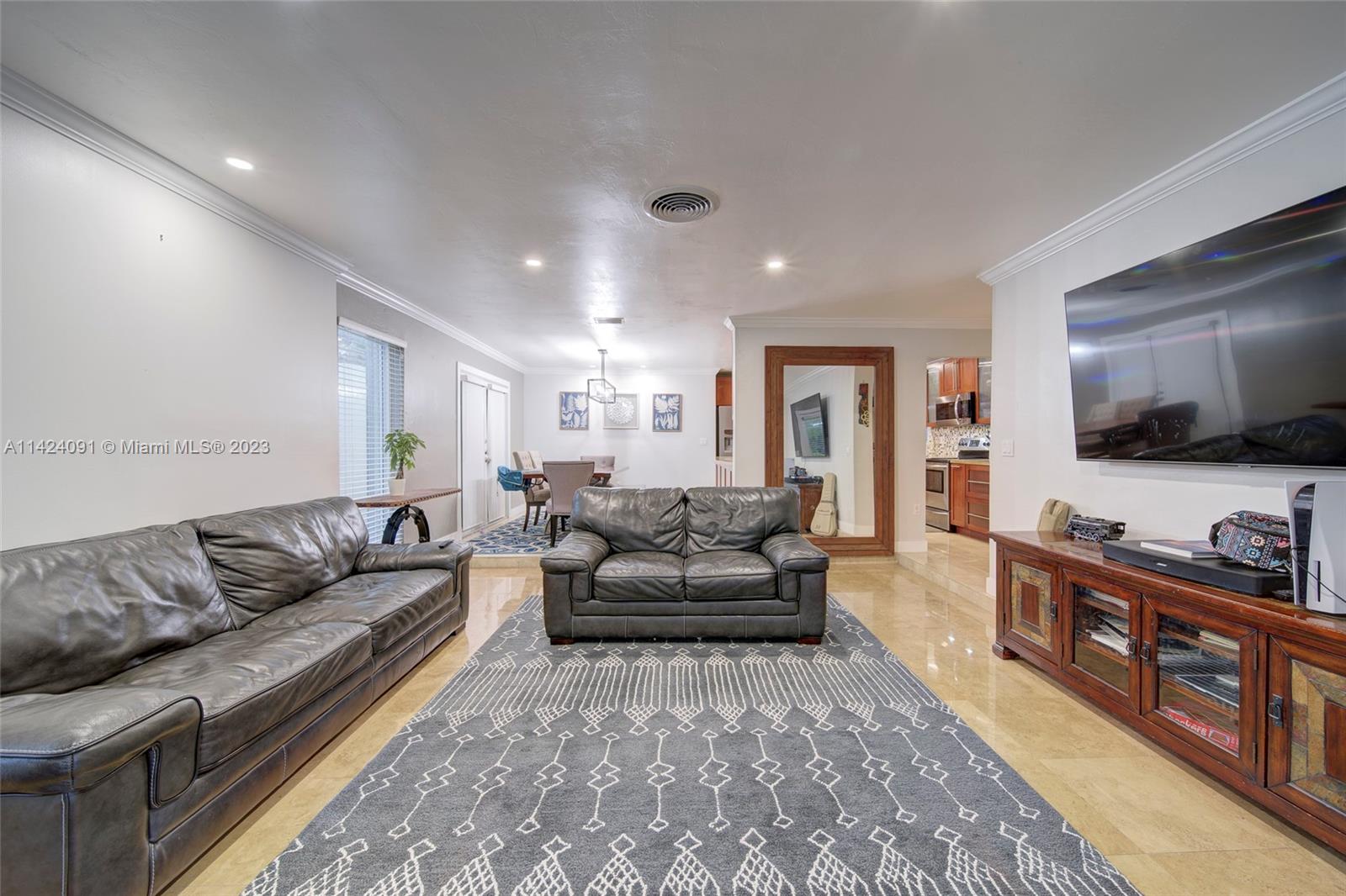 10600 Southwest 108th Terrace Miami, FL 33176 - Photo 11 of 43 a living room with furniture and a flat screen tv