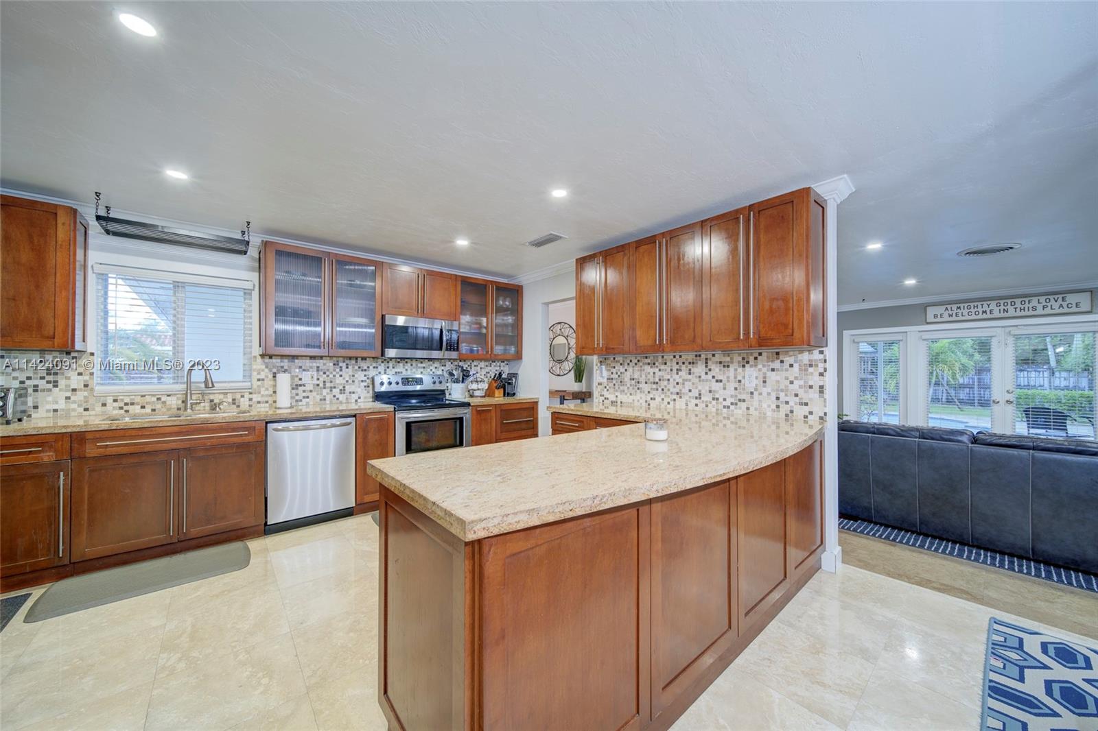10600 Southwest 108th Terrace Miami, FL 33176 - Photo 16 of 43 a kitchen with stainless steel appliances granite countertop wooden cabinets a sink and a oven