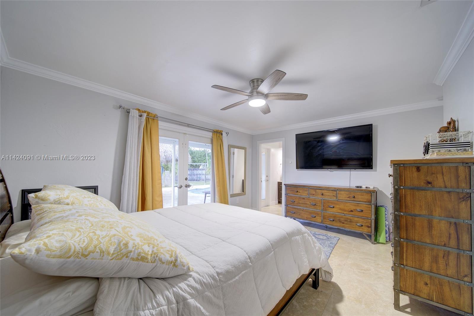 10600 Southwest 108th Terrace Miami, FL 33176 - Photo 19 of 43 a bedroom with a large bed and flat tv