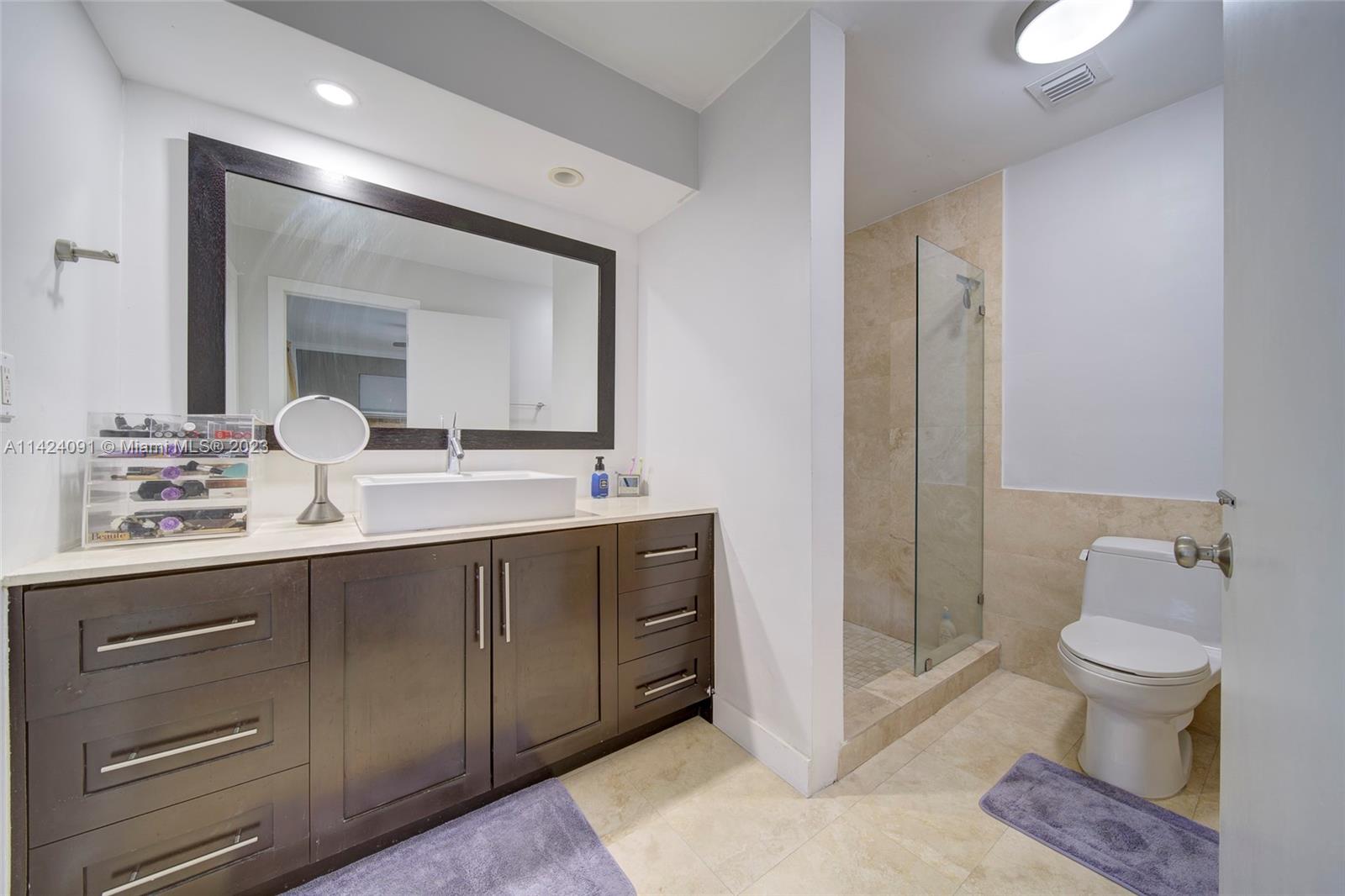 10600 Southwest 108th Terrace Miami, FL 33176 - Photo 21 of 43 a bathroom with a double vanity sink mirror and toilet