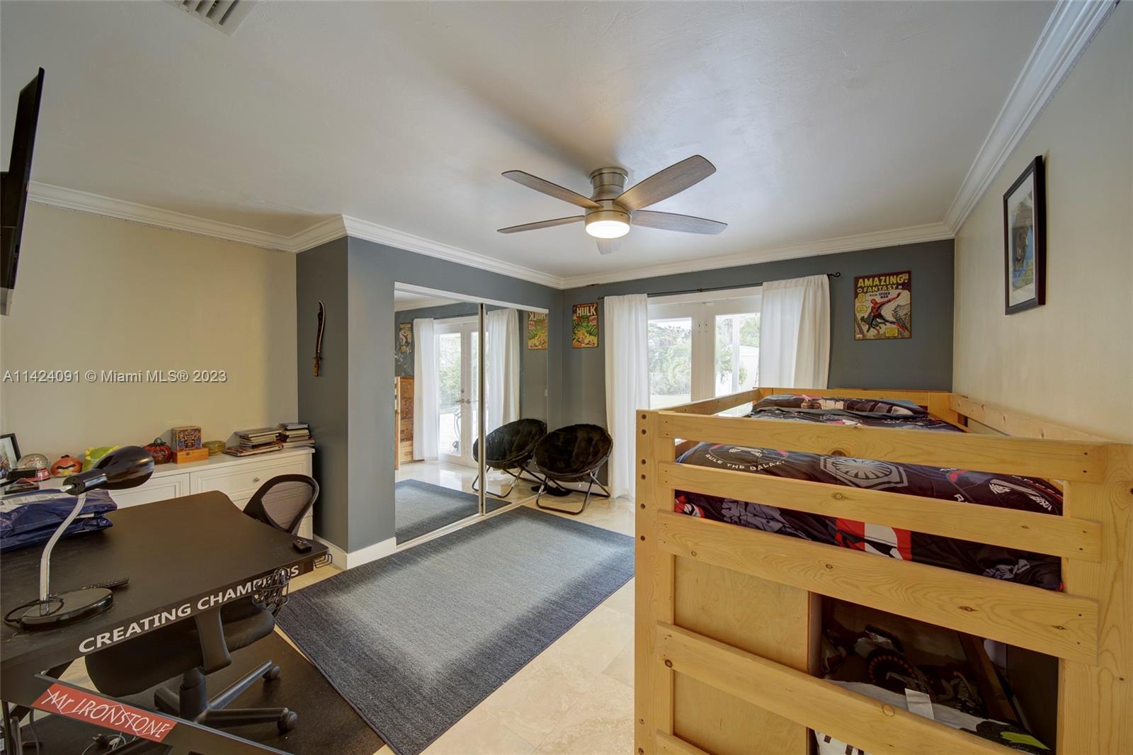 10600 Southwest 108th Terrace Miami, FL 33176 - Photo 25 of 43 a bedroom with a bed a desk and chair