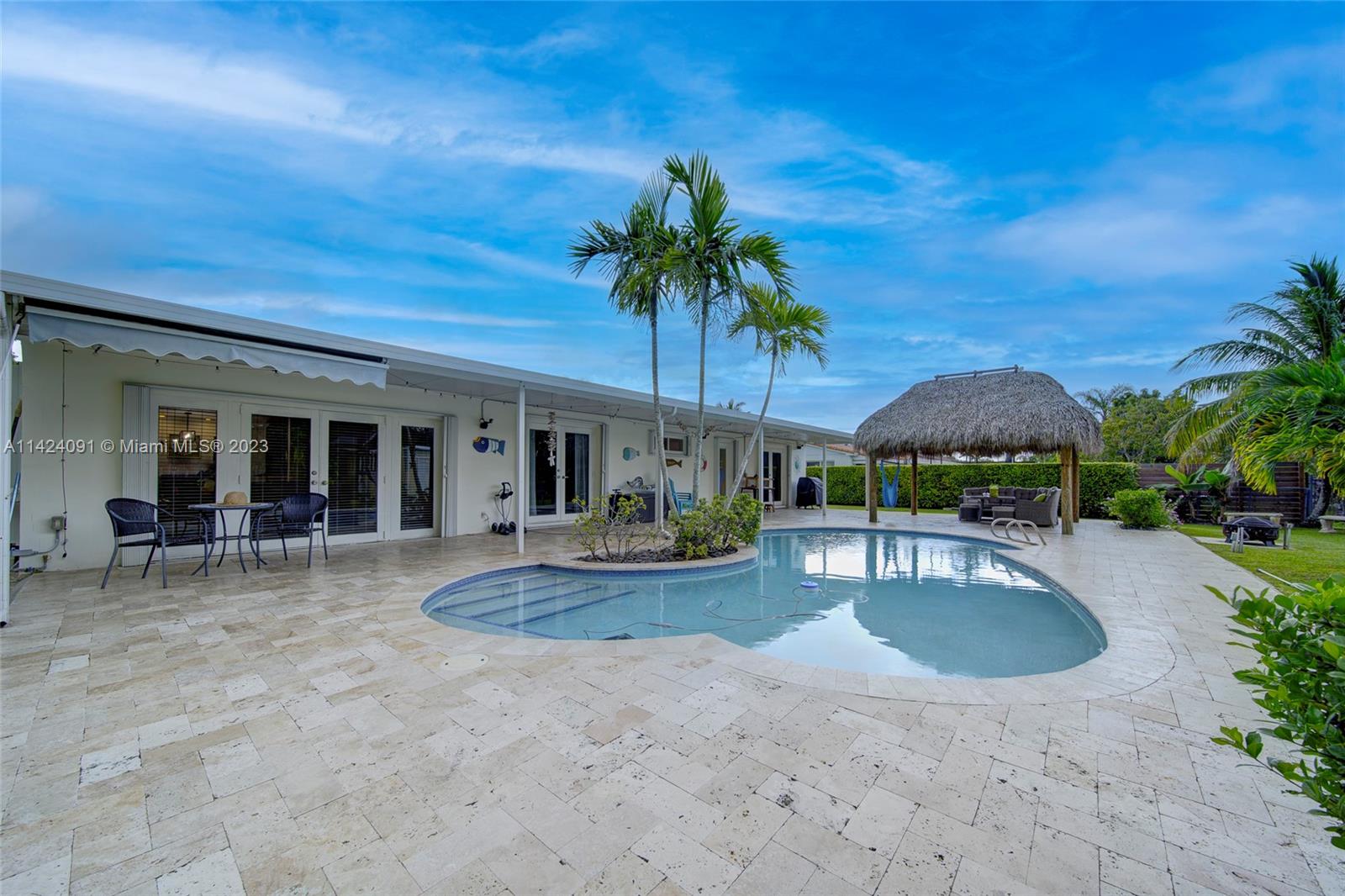 10600 Southwest 108th Terrace Miami, FL 33176 - Photo 32 of 43 a view of a house with backyard patio and swimming pool