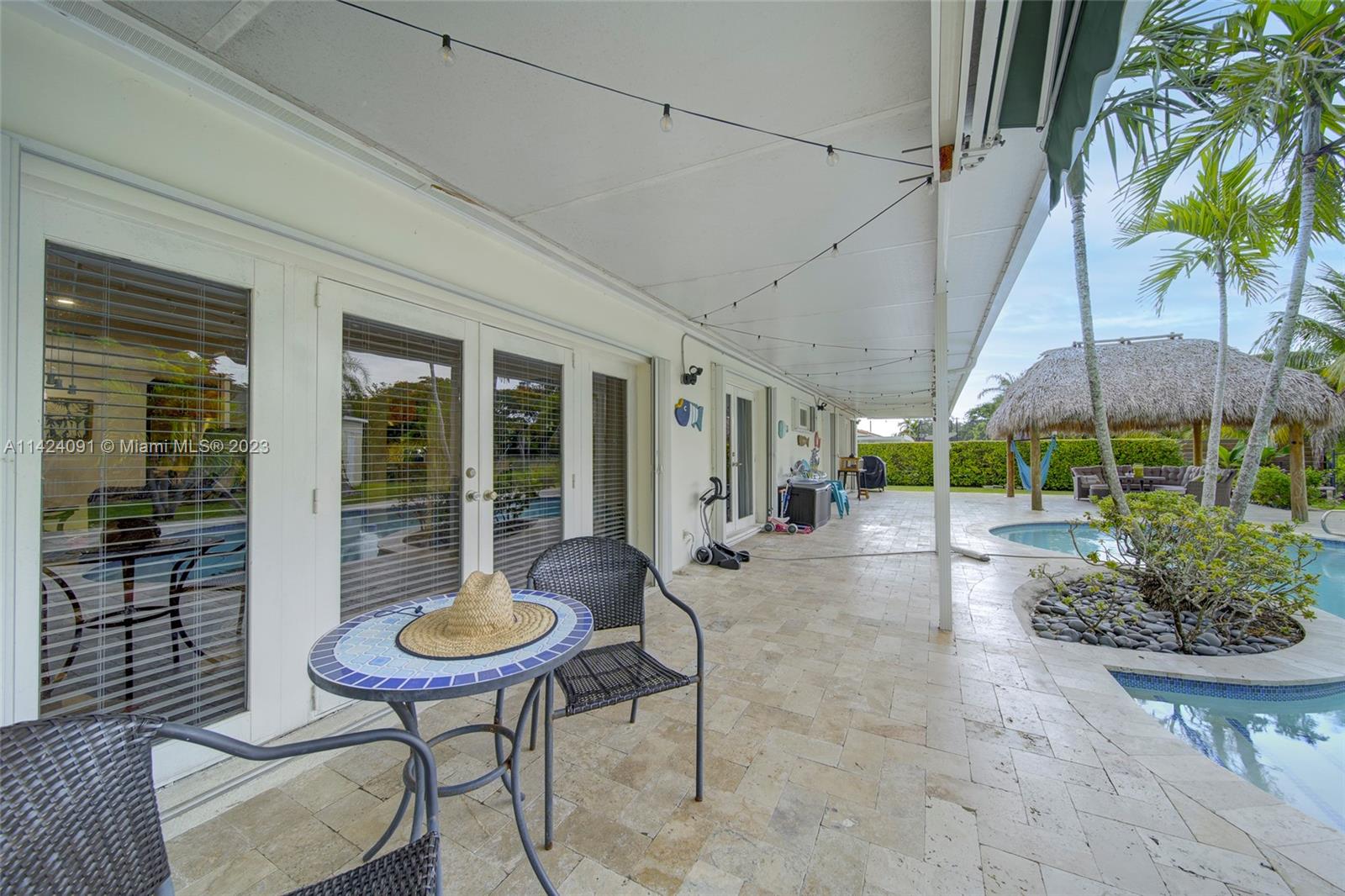 10600 Southwest 108th Terrace Miami, FL 33176 - Photo 34 of 43 a view of a patio with table and chairs potted plants with wooden floor