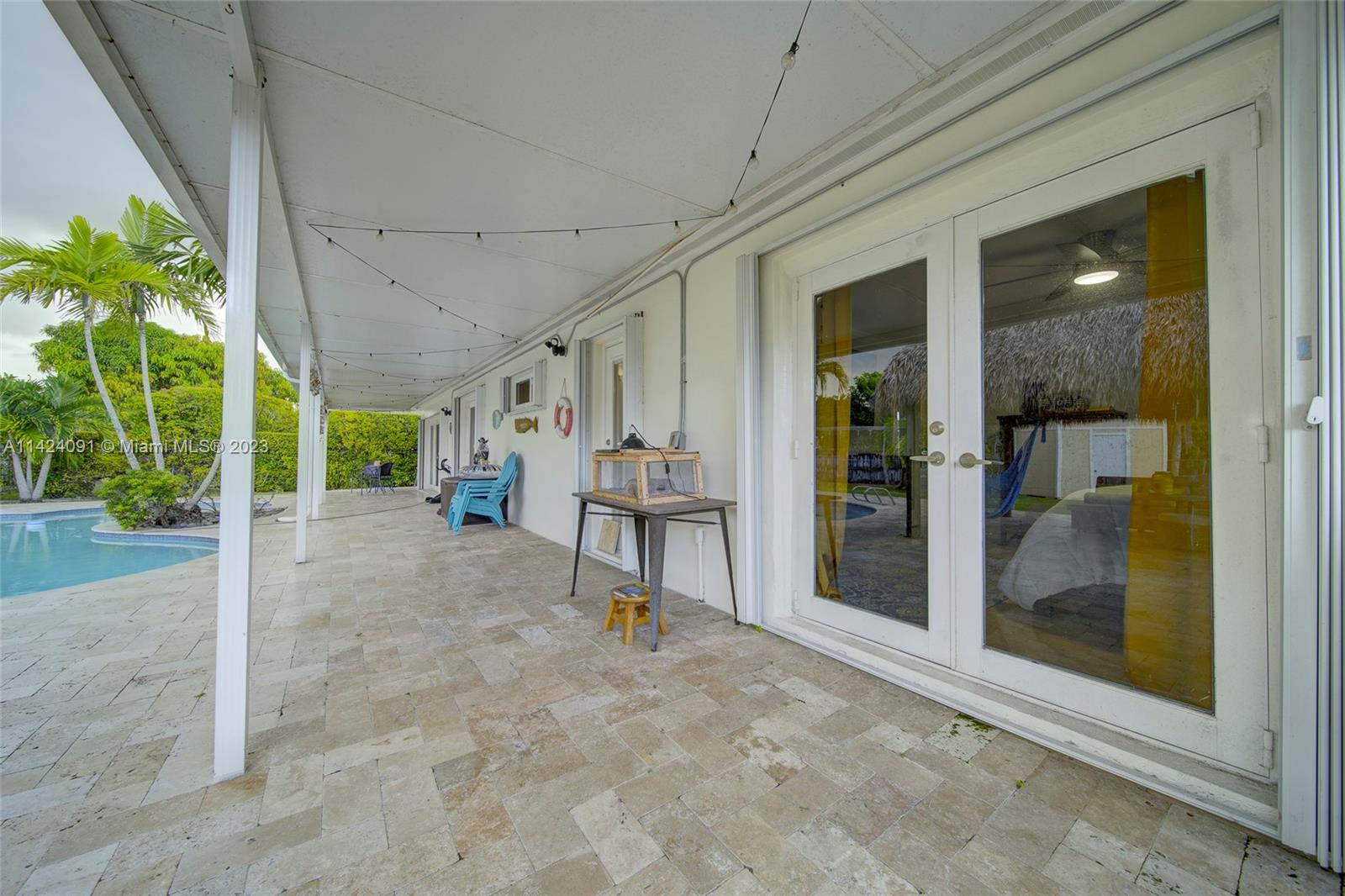 10600 Southwest 108th Terrace Miami, FL 33176 - Photo 36 of 43 a view of a porch with a table and chairs and potted plants