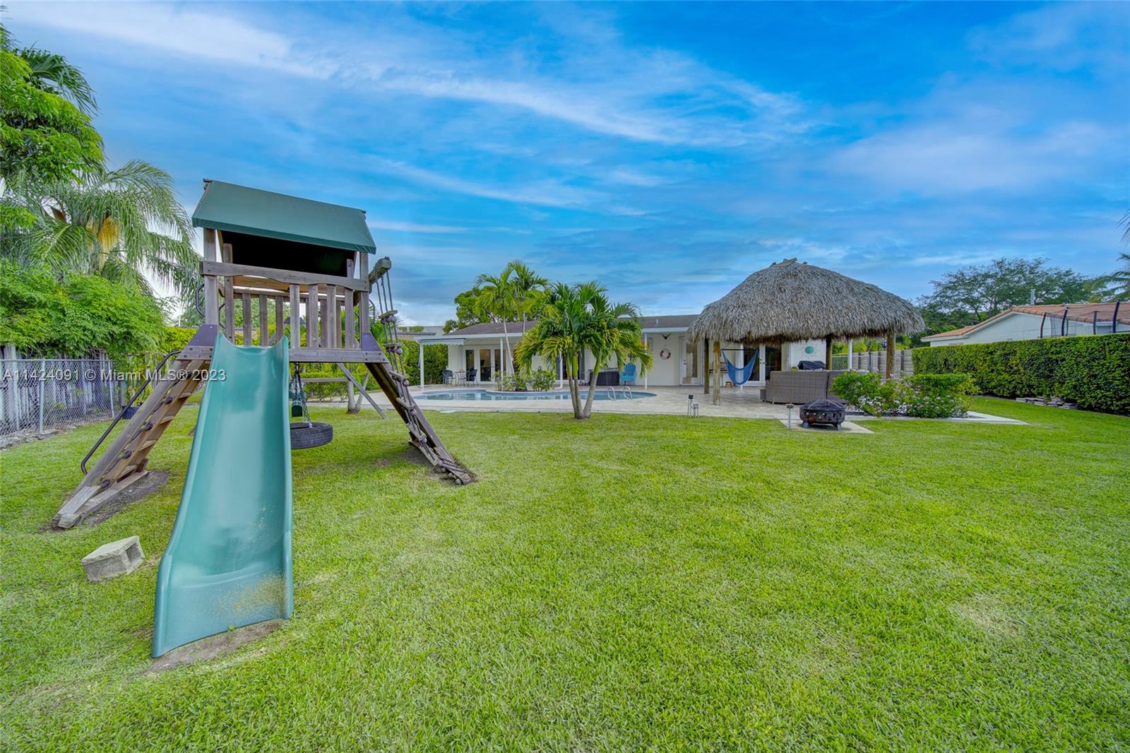 10600 Southwest 108th Terrace Miami, FL 33176 - Photo 39 of 43 a view of a garden with a slide and potted plants