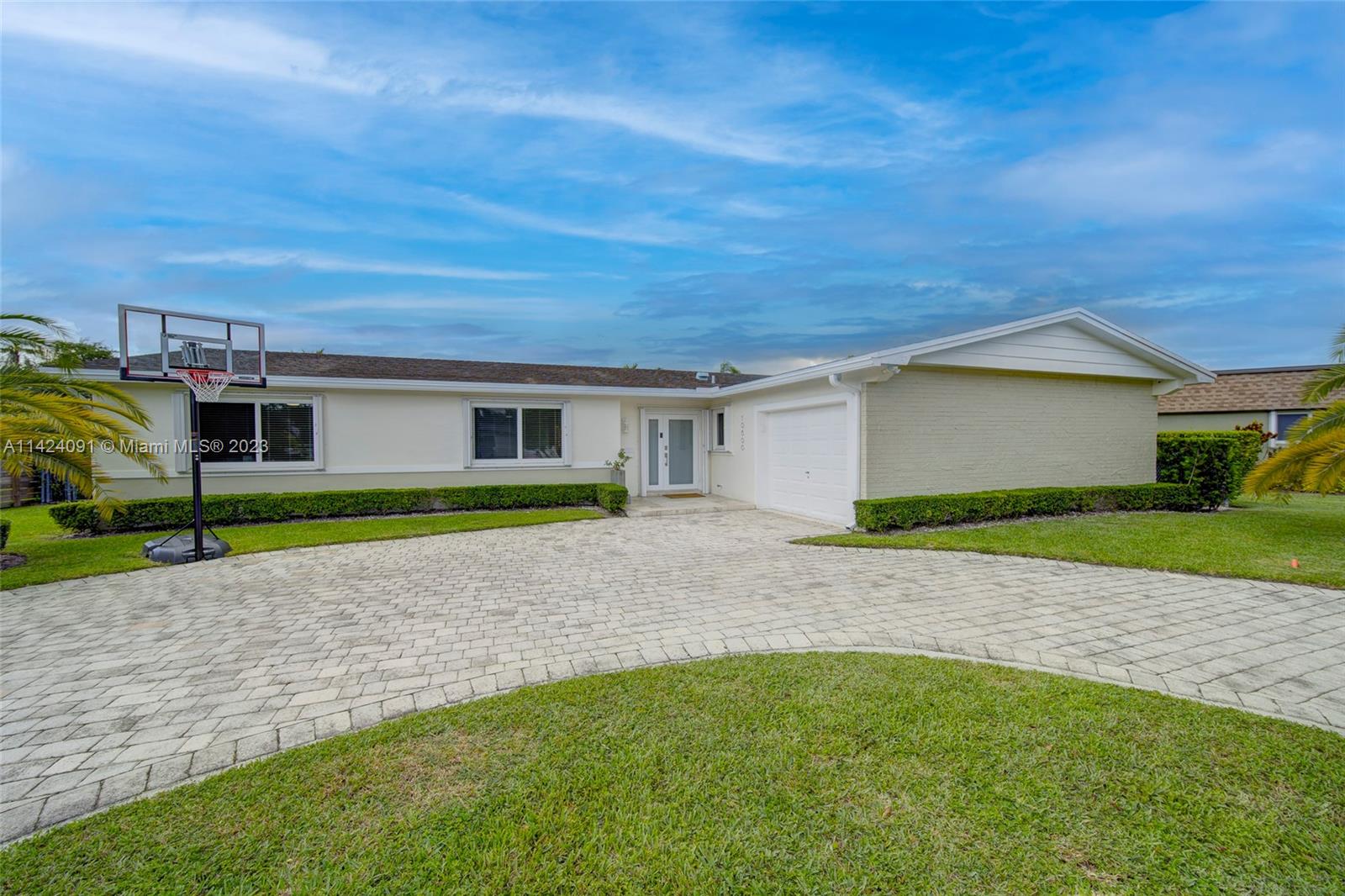 10600 Southwest 108th Terrace Miami, FL 33176 - Photo 4 of 43 a house with green field in front of it