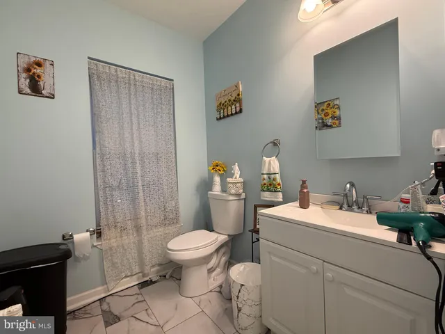 a bathroom with a sink toilet and a shower