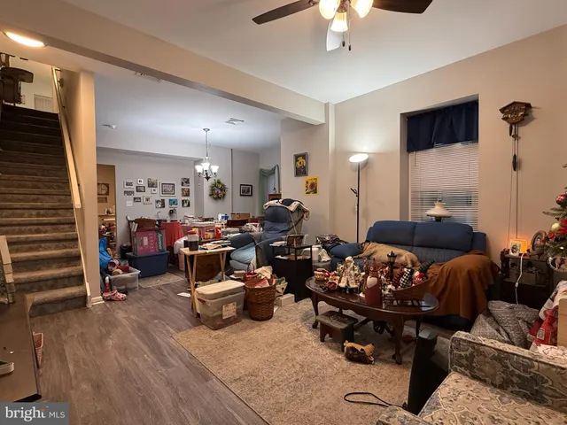 a living room with lots of furniture and wooden floor