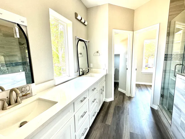 a bathroom with a double vanity sink and a mirror